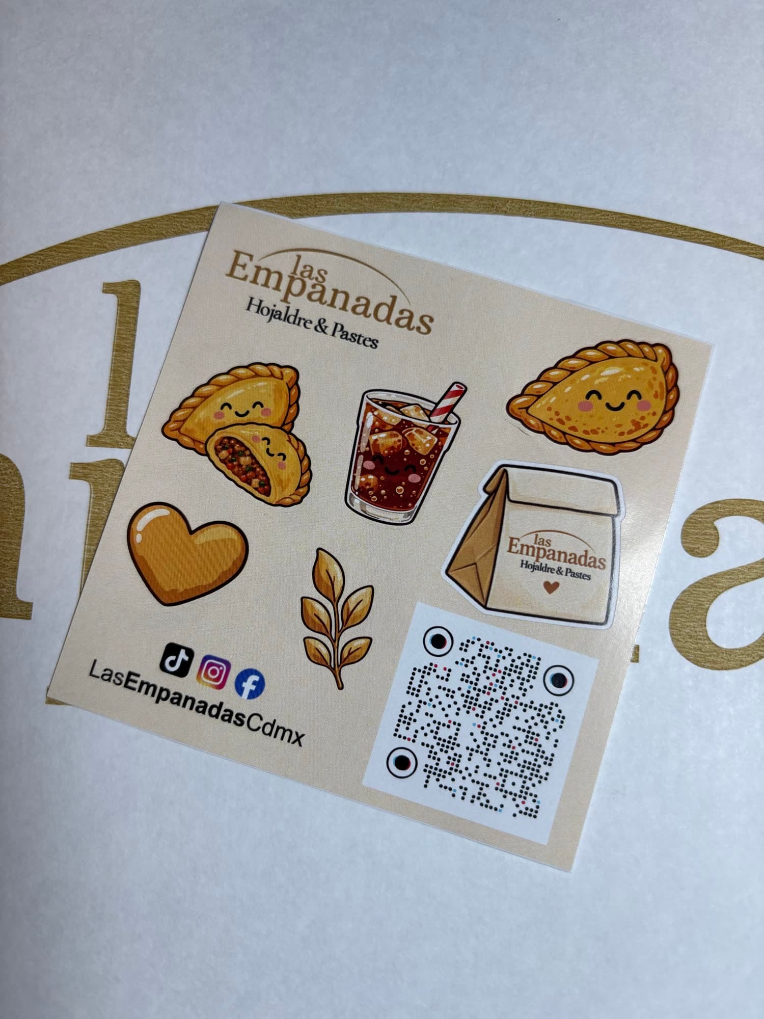 Hoja de stickers de Las Empanadas con el logo y las redes sociales